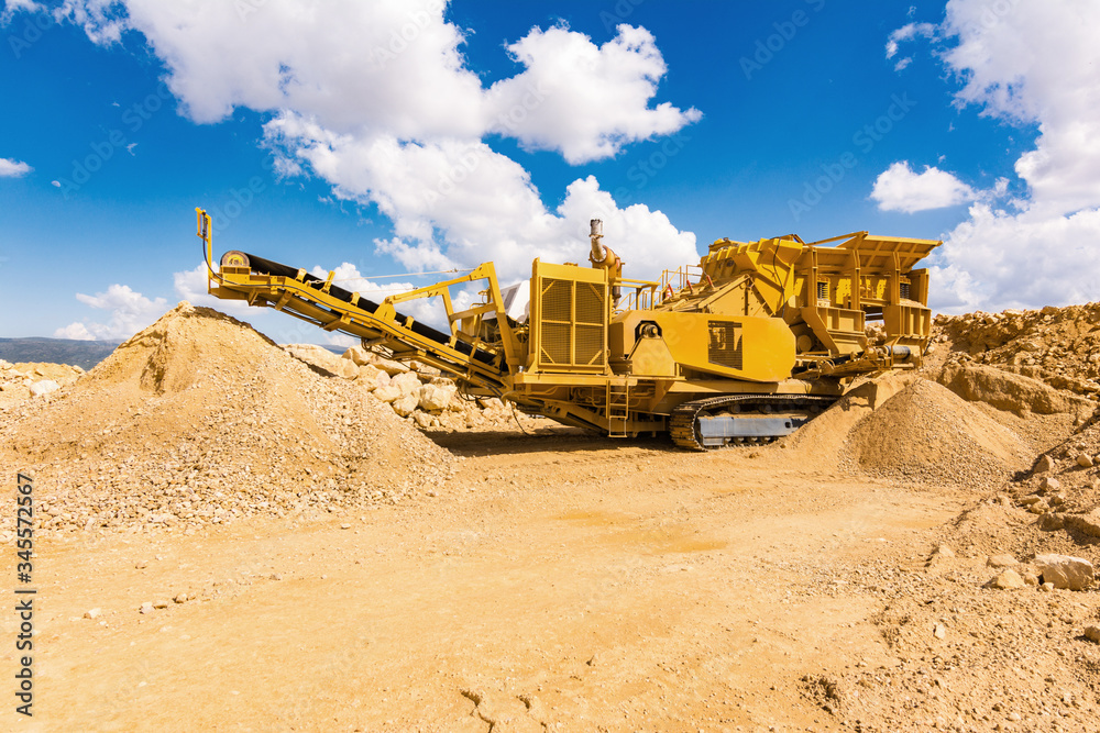Fototapeta premium Transformation of stone and rock into gravel in a quarry