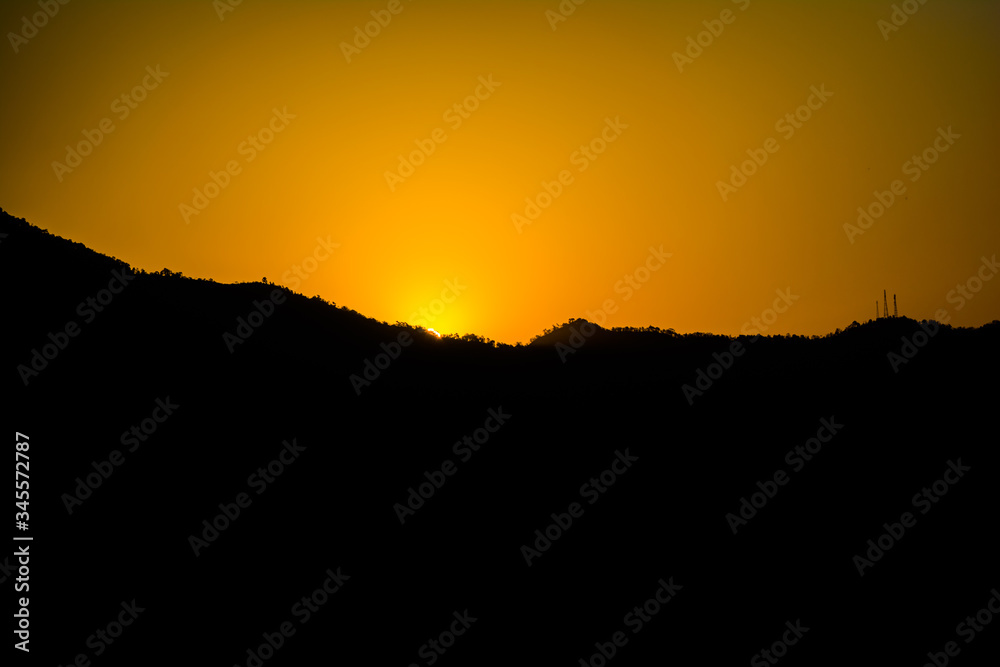 Sunrise behind the mountains of Rishikesh, Located in the foothills of the Himalayas in northern India,

