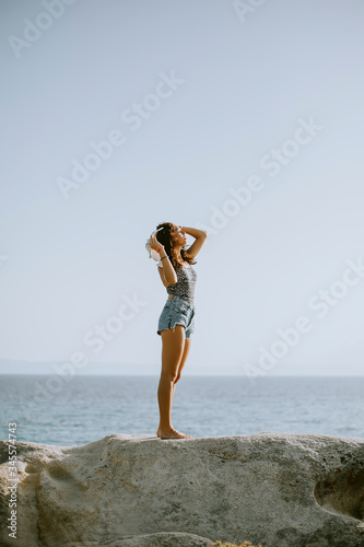 Young woman in bikini stand...
