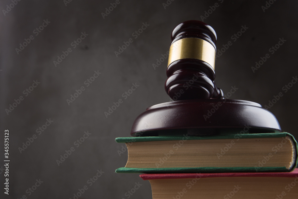 Wooden gavel and books on wooden table - law and auction concept Wooden gavel and books on wooden table - law and auction concept