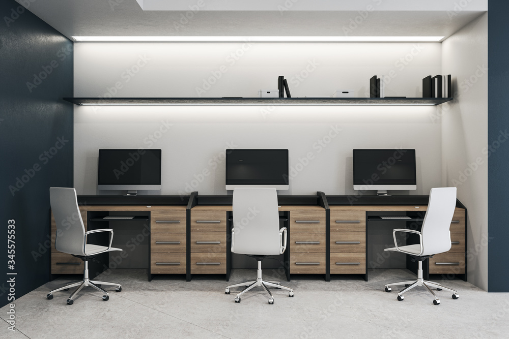 Modern coworking office interior with three computers Modern coworking office interior with three computers