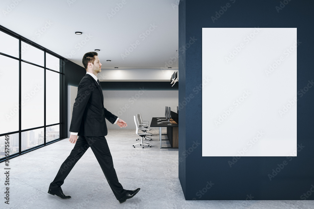 Fototapeta premium Businessman walking in loft coworking office interior