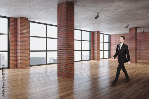 Businessman walking in contemporary red brick room
