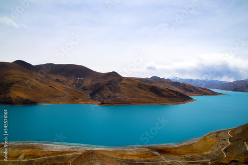 The brown peaks of YamdrokTso, the blue-green sacred lake, and Mani Dui and the dancing prayer flags.