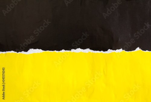 Black and yellow torn and crumpled paper poster. Old dirty ripped and peeling grunge paper placards texture background. Copy space for text.