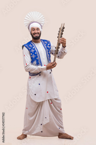 Portrait Of Sikh man Holding A Chimta 