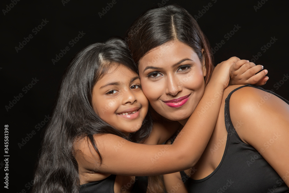 Portrait of smiling mother and daughter embracing
Portrait of smiling mother and daughter embracing