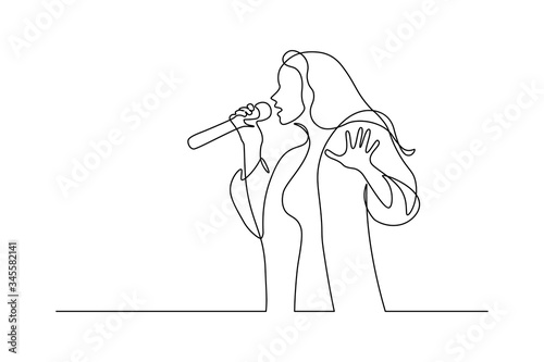 Singer in continuous line art drawing style. Young woman holding microphone and singing. Black linear sketch isolated on white background. Vector illustration photo