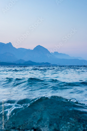 Seascape with a silhouette of mountains and the sea in blue tones.