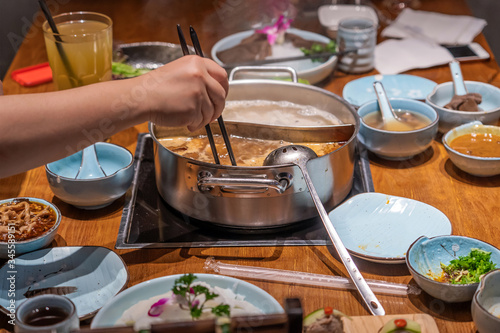 Picking food from boiling hotpot
