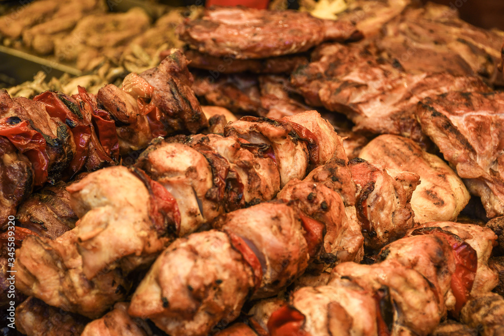 Assorted delicious grilled meat with vegetables over the counter on a barbecue event. Assorted delicious grilled meat with vegetables over the counter on a barbecue event.