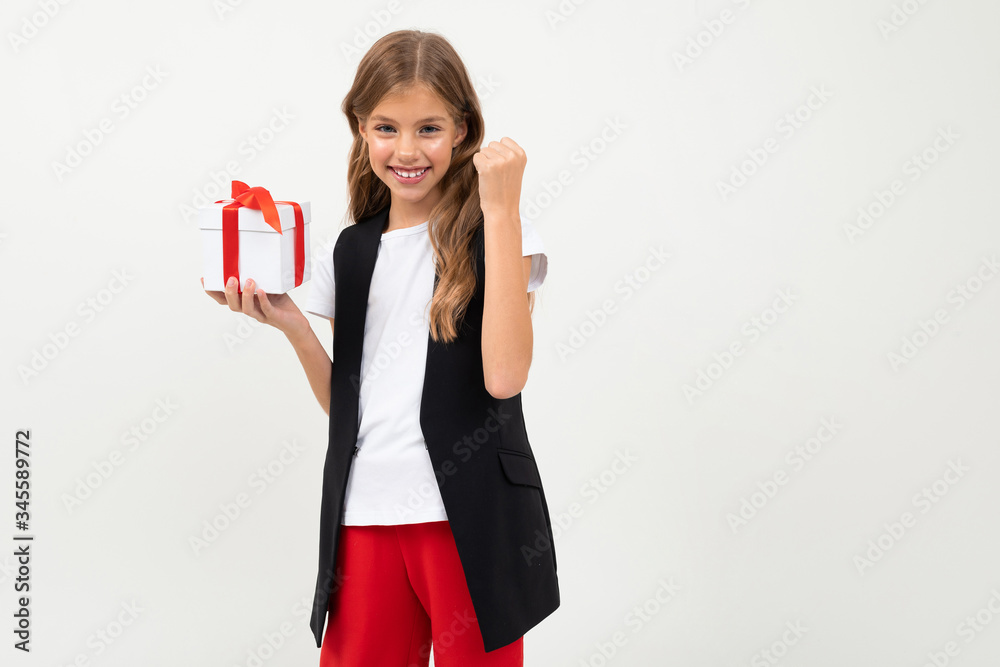 Pretty little girl in costume stands with gift isolated on white background Pretty little girl in costume stands with gift isolated on white background