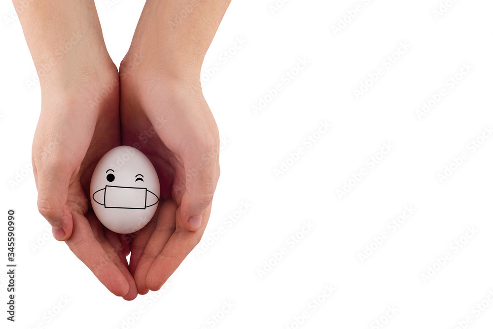 A white chicken egg in a medical mask lies in the palms. Easter Egg Protection Concepts with Corona Virus (COVID19). Easter eggs in a mask. Safety comes first during Easter 2020. Copy space isolated. A white chicken egg in a medical mask lies in the palms. Easter Egg Protection Concepts with Corona Virus (COVID19). Easter eggs in a mask. Safety comes first during Easter 2020. Copy space isolated.