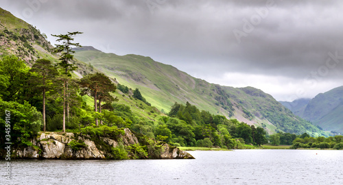 The bank of Ullswater in the Lake District showing the rambling hills and calm water. 