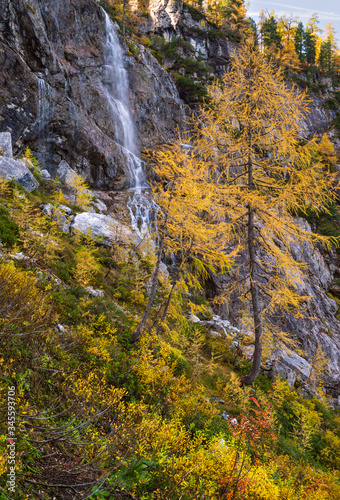 Autumn alpine waterfall view from mountain hiking path to Tappenkarsee  Kleinarl  Land Salzburg  Austria.