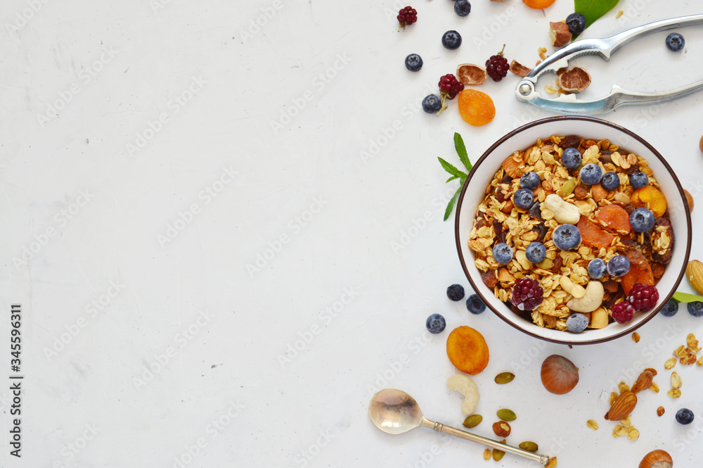 Healthy food vegan breakfas: homemade granola with nuts, seeds, blueberries, strawberries nutrition concept. organic food on table, detox diet .Healthy food vegan breakfast. copy space. Healthy food vegan breakfas: homemade granola with nuts, seeds, blueberries, strawberries nutrition concept. organic food on table, detox diet .Healthy food vegan breakfast. copy space.