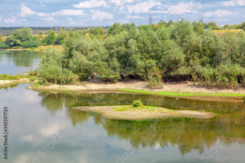 scenery with small green islands on the river