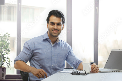 Portrait of smiling businessman at desk in office  © IndiaPix