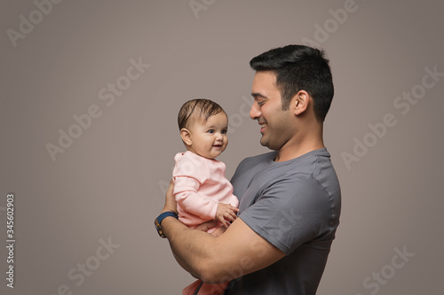 Smiling Father Playing baby girl
