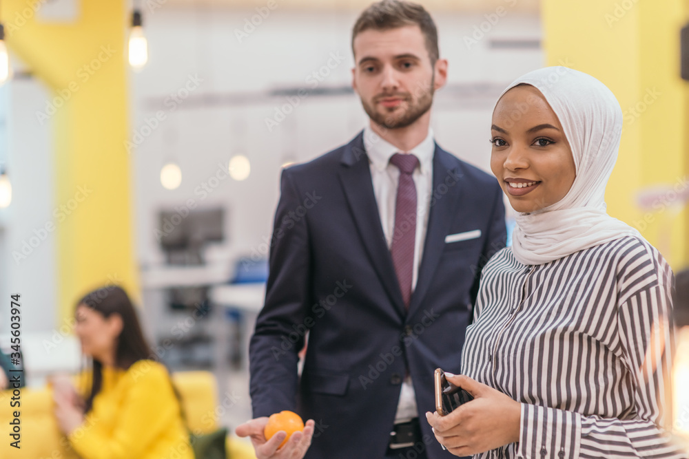 Portrait of a Muslim African American businesswoman at work while standing in the middle of a modern office. Portrait of a Muslim African American businesswoman at work while standing in the middle of a modern office.