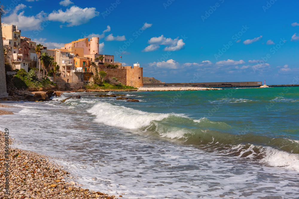 Sunny medieval fortress in Cala Marina, harbor in coastal city Castellammare del Golfo and Cala Petrolo Beach, Sicily, Italy