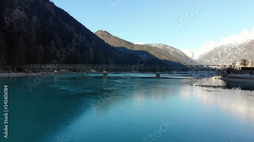 Flying pan towards bridge by drone on blue lake 