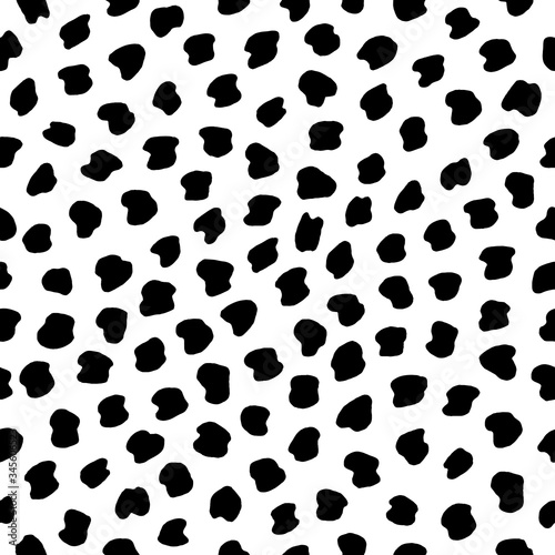 Hand drawn black and white seamless dot pattern. Vector abstract texture with chaotic spots.