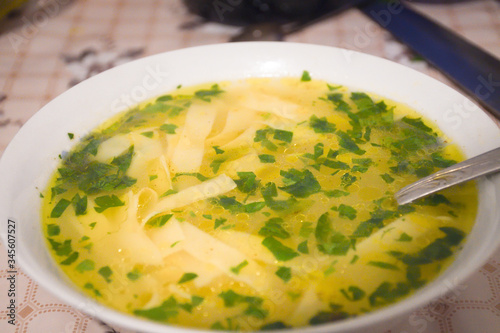 Traditional romanian supa cu galuste or soup with dumplings. Chicken stock soup with parsley
