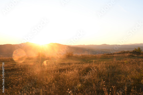 Romantic scenery during autumn sunset. Hills and mountains in the background