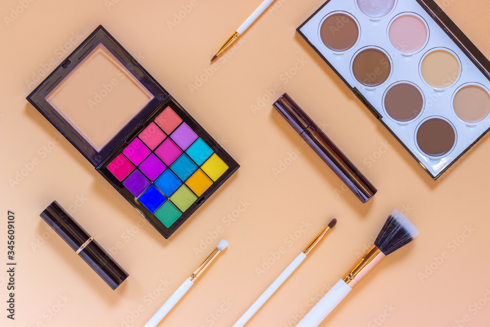 Set of professional decorative cosmetics with accessories.Makeup brushes eye shadow black mascara contouring palette contour lipstick on color background.Make-up and beauty concept.Flat lay top view Set of professional decorative cosmetics with accessories.Makeup brushes eye shadow black mascara contouring palette contour lipstick on color background.Make-up and beauty concept.Flat lay top view