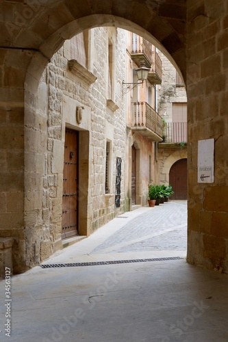 Calaceite village, Teruel, Aragon, Spain empty street of a tourist village, entrance to the ancient courtyard under the arch. photo