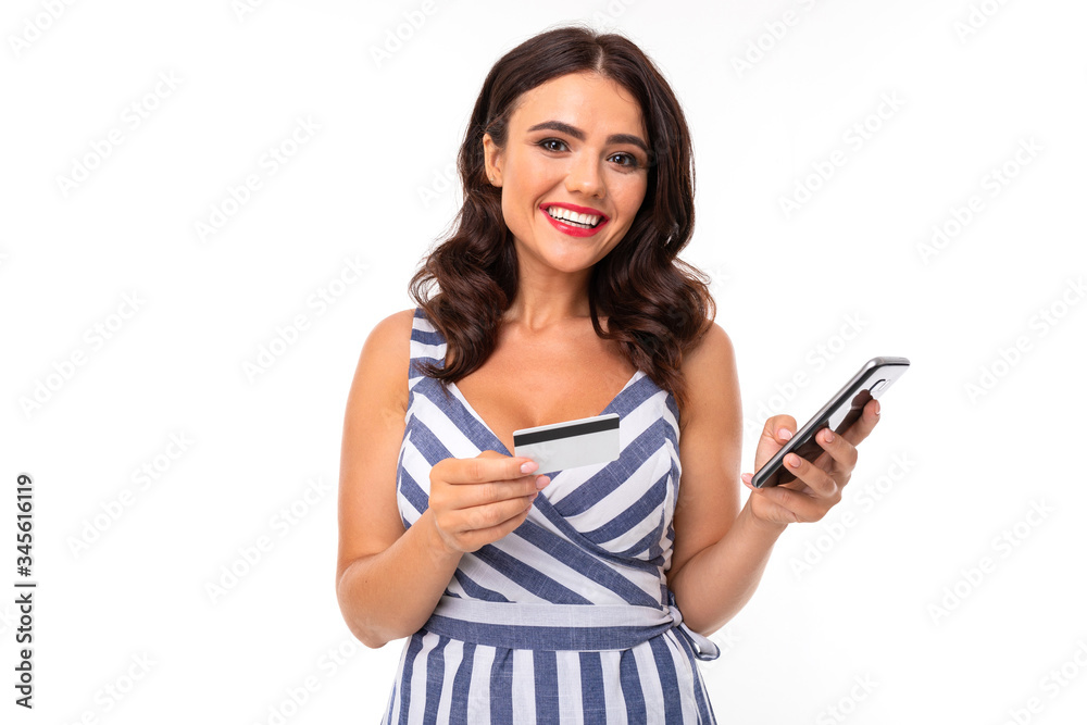 Portrait of nice caucasian girl holds a phone and credit card isolated on white background Portrait of nice caucasian girl holds a phone and credit card isolated on white background