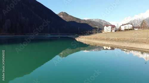 Aerial shot above lake in alpine village 
