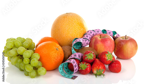 Diet scenery with fresh fruit over white background