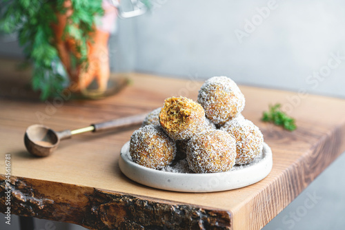 Healthy Organic Gluten and Sugar Free Dessert of Carrot Balls, Coconut flacks and nut Creme photo