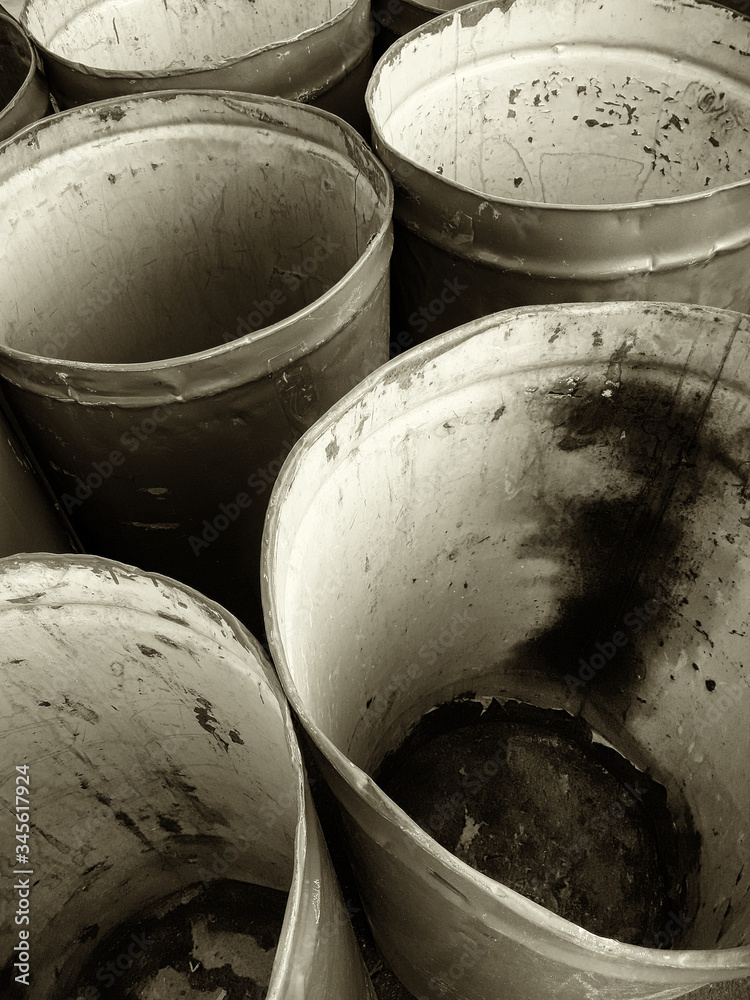 Warehouse trading company. There are a lot of empty old barrels in the frame. Vertical shot. Black-and-white image, sepia. Photographed in Ukraine, Kiev region. Warehouse trading company. There are a lot of empty old barrels in the frame. Vertical shot. Black-and-white image, sepia. Photographed in Ukraine, Kiev region.
