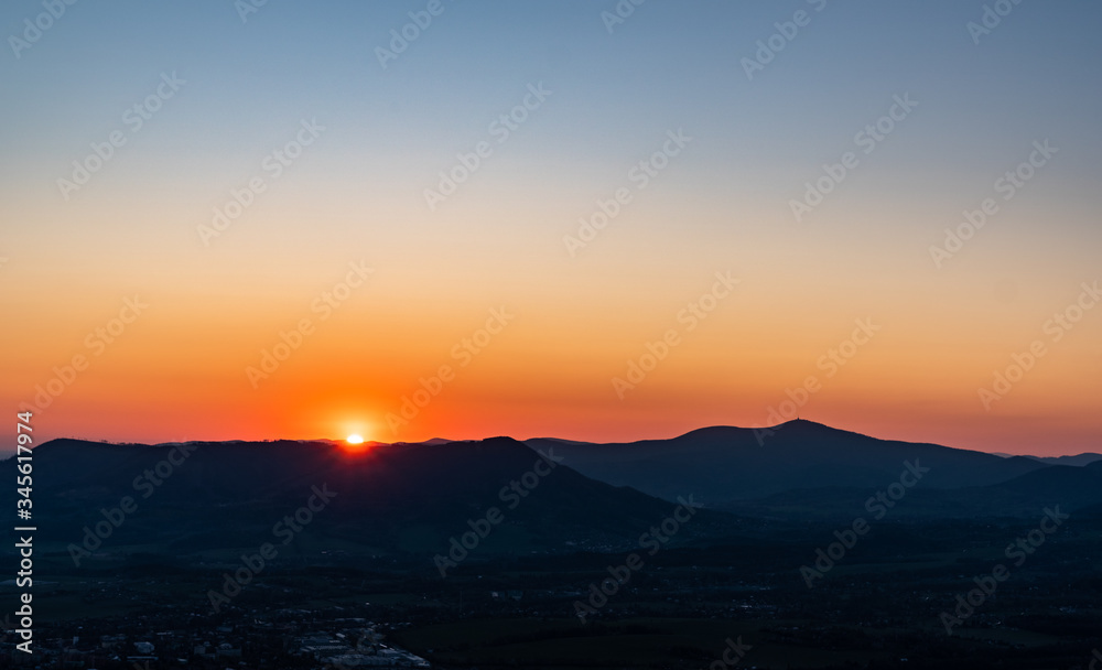 sunrise with silhouette of mountains in Beskydy mountains, Czech Velky Javornik
