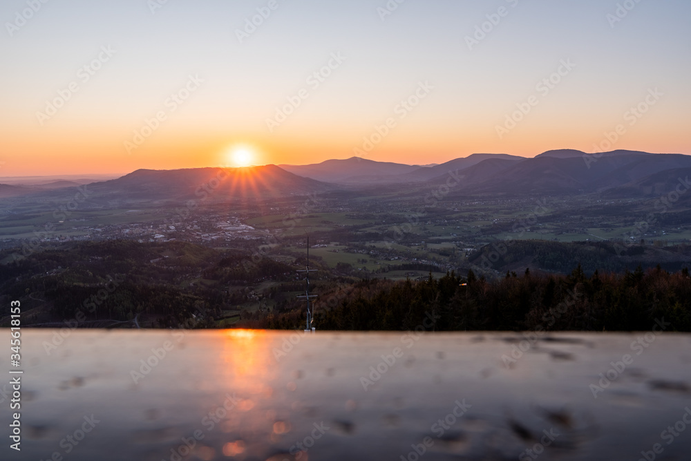 Fototapeta premium sunrise in the valley of a beautiful green field in spring with fog, Czech Beskydy Frenstat pod Radhostem