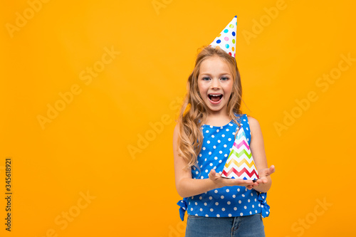 Nice little girl with a birthday party isolated on white background