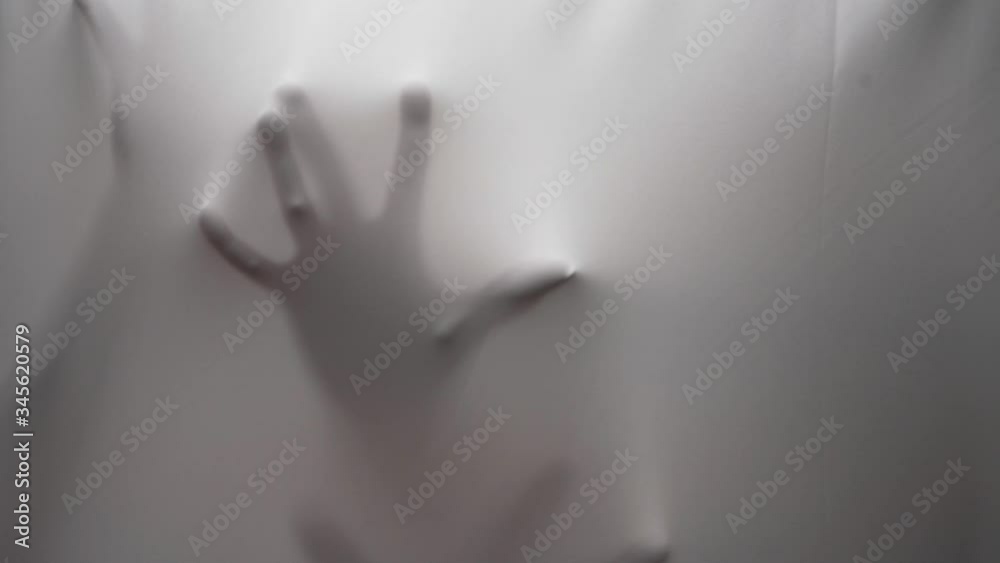 Creativity performing of moves with hands behind curtain