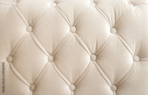 Light beige velour textile diamond pattern with buttons. Background concept. Furniture sofa cover. photo