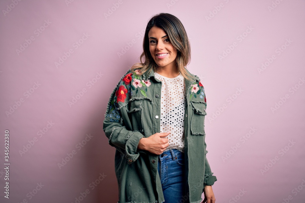 Young beautiful woman wearing fashion urban clothes, model wearing casual street style standing over pink background Young beautiful woman wearing fashion urban clothes, model wearing casual street style standing over pink background