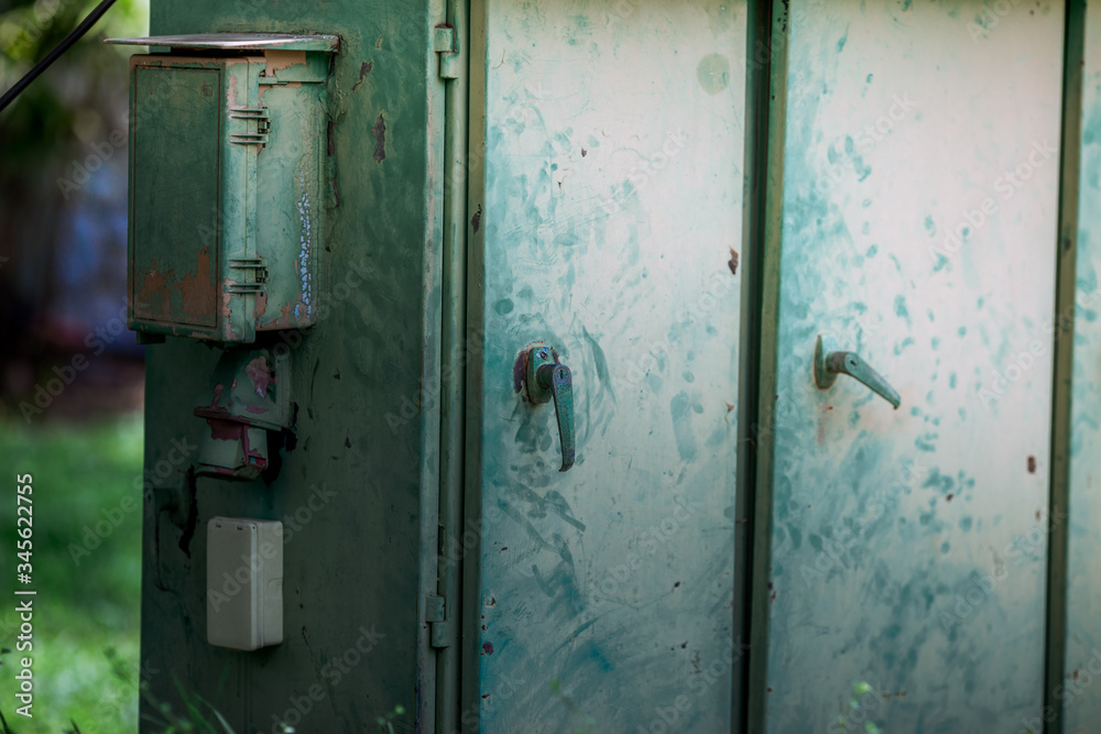 The blurred abstract background of an electric control cabinet that exists between public gardens or the streets, for the convenience of emergency remedies in the event of a power failure. The blurred abstract background of an electric control cabinet that exists between public gardens or the streets, for the convenience of emergency remedies in the event of a power failure.