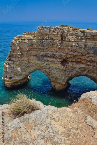 Double arched cliffs formed almost as a heart at Praia da Marinha, Lagoa © nicolecedik