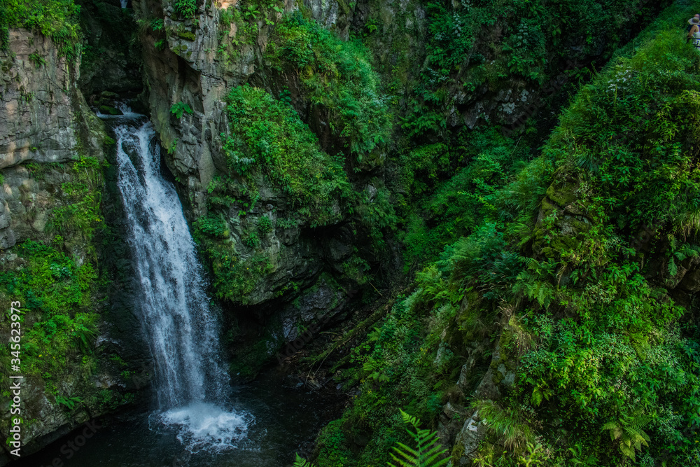 Rough, mountain waterfall in the forest. Landscape of Miedzygorze, Sudety, Poland.