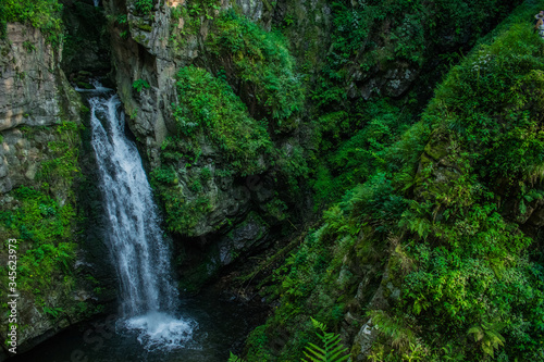 Rough, mountain waterfall in the forest. Landscape of Miedzygorze, Sudety, Poland.