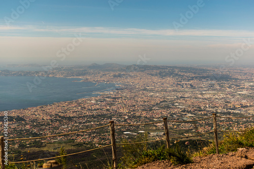 Amazing landscape view seen from Vesuvius Mountain (volcano crater). In the background Naples cityscape, Gulf of Naples (Bay of Naples), blue sky with clouds. Beautiful postcard from Napoli, Italy.