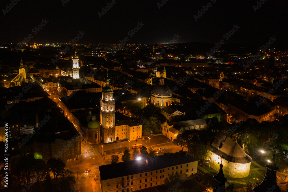 Aerial view on Dominican Church and Dormition Church in Lviv, Ukraine from drone at night