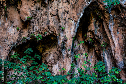 Mediterranean landscape of Sicily, Italy. View of beautiful cave shot in Zingaro Nature Reserve. Mix of rocks, mountain, plants, darkness, mystery, fear, adventure. 