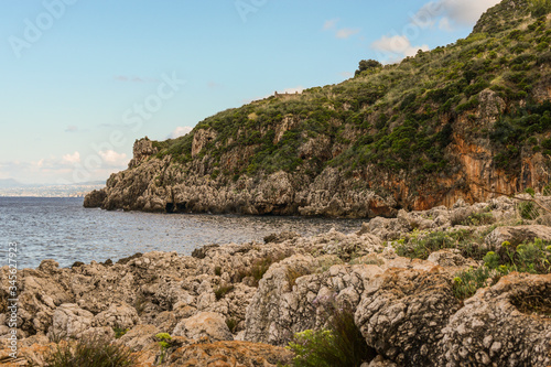 Mediterranean landscape of Sicily, Italy. View shot in Zingaro Nature Reserve. Mix of azur water, rock, coast, mountain, plants, sea, flora and hill. 